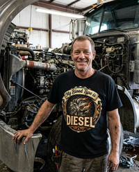 Load image into Gallery viewer, Diesel mechanic wearing My Blood Type Is Diesel tee at the engine bay