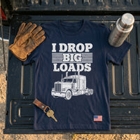 Load image into Gallery viewer, I Drop Big Loads t-shirt flat lay on truck bed with work gloves, keys and thermos