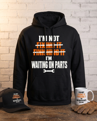 Load image into Gallery viewer, I'm Not Fixing It, I'm Waiting On Parts hoodie standing on a workbench