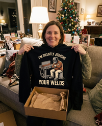 Load image into Gallery viewer, Holding up the Silently Judging Your Welds hoodie as a Christmas gift