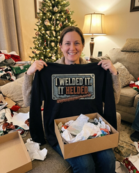 Load image into Gallery viewer, Holding up the I Welded It It Helded hoodie as a Christmas gift