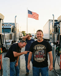 Load image into Gallery viewer, Truckers laughing at the I Drop Big Loads shirt at the fuel island