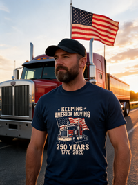 Load image into Gallery viewer, Trucker wearing Keeping America Moving navy shirt in front of a big rig with American flag at sunset